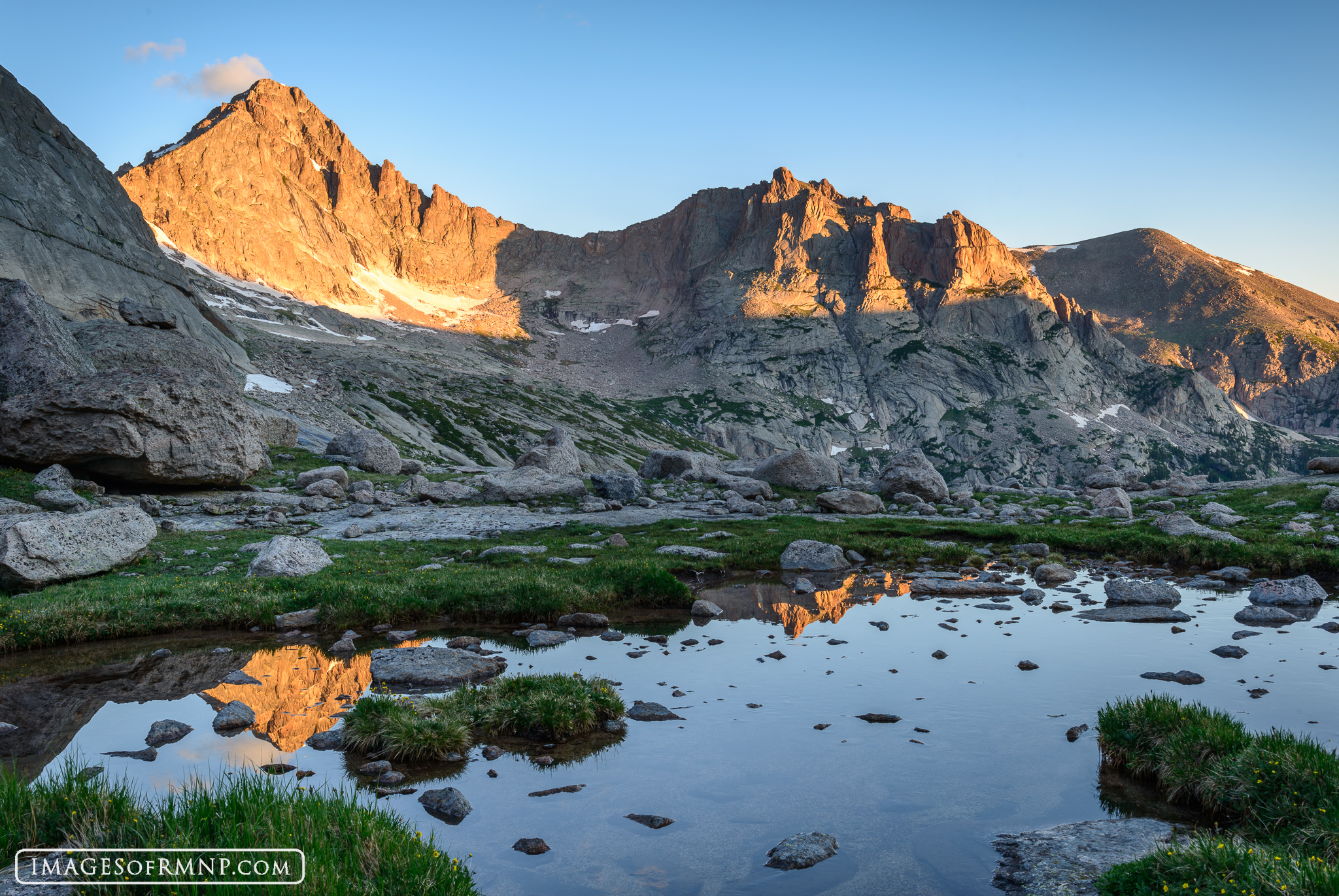 McHenrys Peak and Arrowhead glow in the morning's first light in Glacier Gorge, Rocky Mountain National Park.